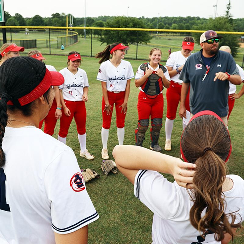 Coach Eric Lee gives softball team a pep talk before first game of NJCAA World Series tournament.